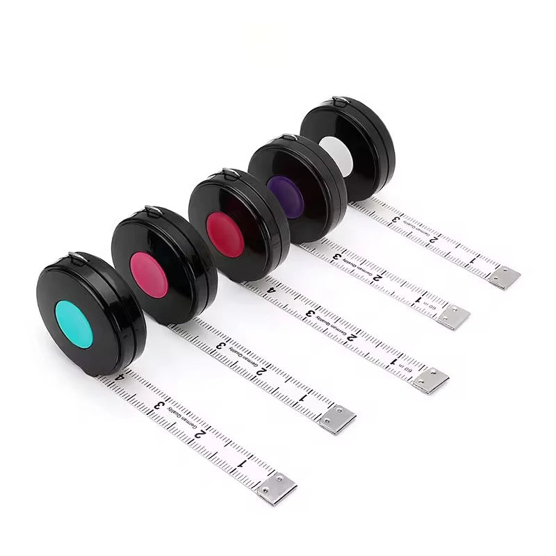 Set of five black measuring tools with colored ends on a white background
