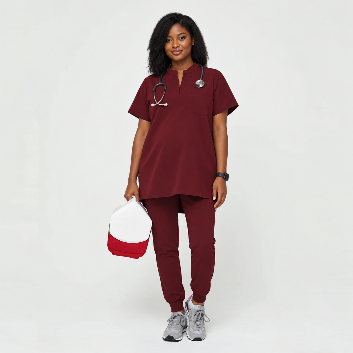 SMSG maternity scrubs complete set in burgundy on pregnant healthcare worker with stethoscope full body front view showing mandarin collar top and jogger pants