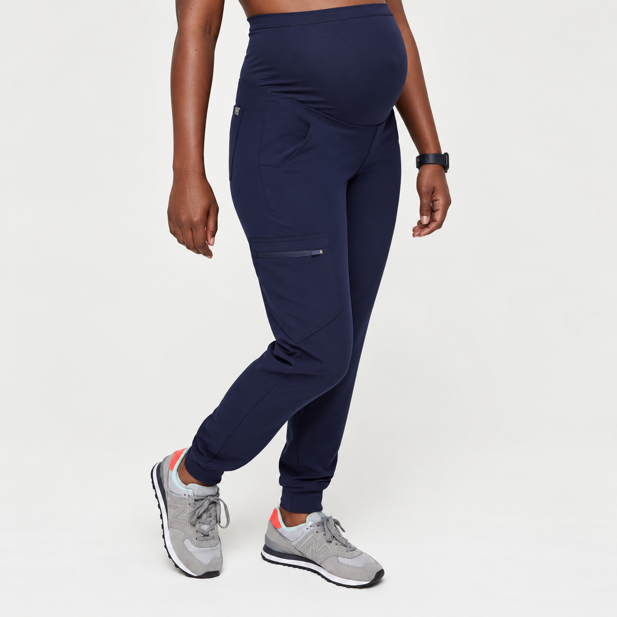 Navy blue SMSG maternity jogger pants side view showing over-belly panel and angled side cargo pocket detail